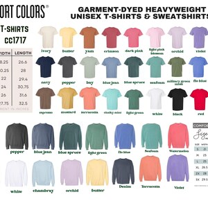 The image is a color chart for various sizes of T-shirts and sweatshirts, displaying a range of colors from white to dark pink.