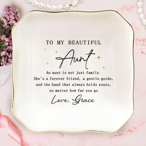 May include: A white ceramic trinket dish with a gold rim. The dish is inscribed with the words "TO MY BEAUTIFUL Aunt" and a heartfelt message. A thoughtful gift for an aunt.