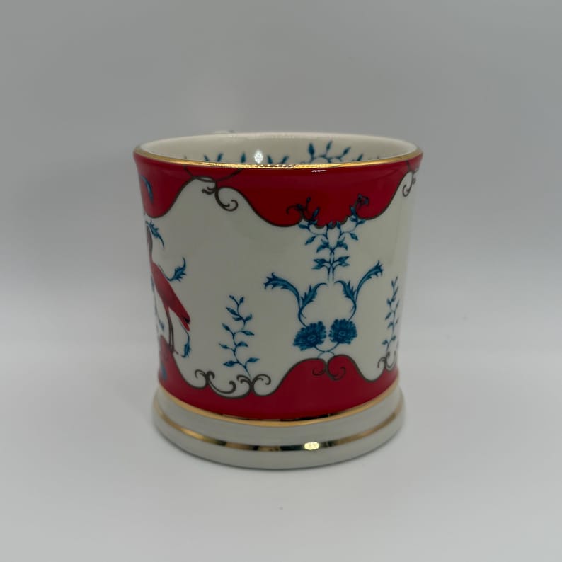 May include: A set of three ceramic mugs with a speckled, matte finish. The mugs are in shades of cream, light gray, and dark gray. Each mug has a simple, minimalist design and a rounded handle.