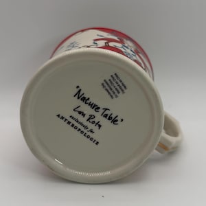 May include: A set of three ceramic mugs with a speckled, matte finish. The mugs are in shades of cream, light gray, and dark gray. Each mug has a simple, minimalist design and a rounded handle.