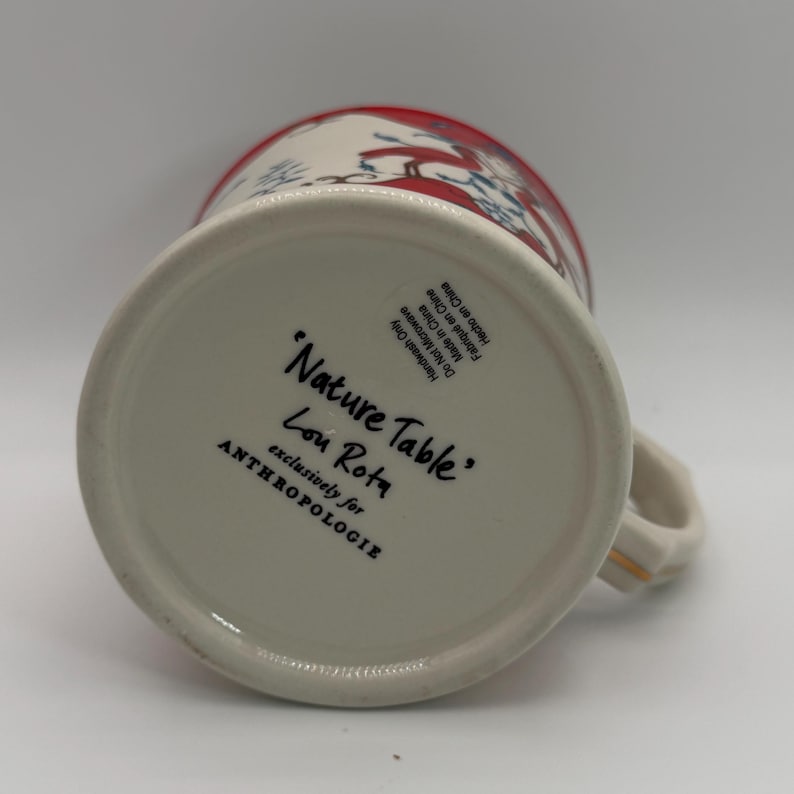 May include: A set of three ceramic mugs with a speckled, matte finish. The mugs are in shades of cream, light gray, and dark gray. Each mug has a simple, minimalist design and a rounded handle.