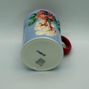 May include: A set of three ceramic mugs with a speckled, matte finish. The mugs are in shades of cream, light gray, and dark gray. Each mug has a simple, minimalist design, perfect for coffee or tea.