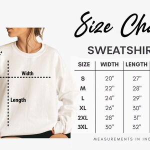 May include: A white sweatshirt with a size chart. The chart shows measurements in inches for width, length, and sleeve length for sizes S to 3XL. The text "Size Chart" is at the top.