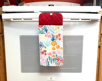 Bold flower potholder towel with button top for oven door handle. Decorative hanging towels that won't fall on the floor for convenient use.