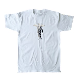 May include: White t-shirt with a black and gold graphic of a person standing on a snake with wings.