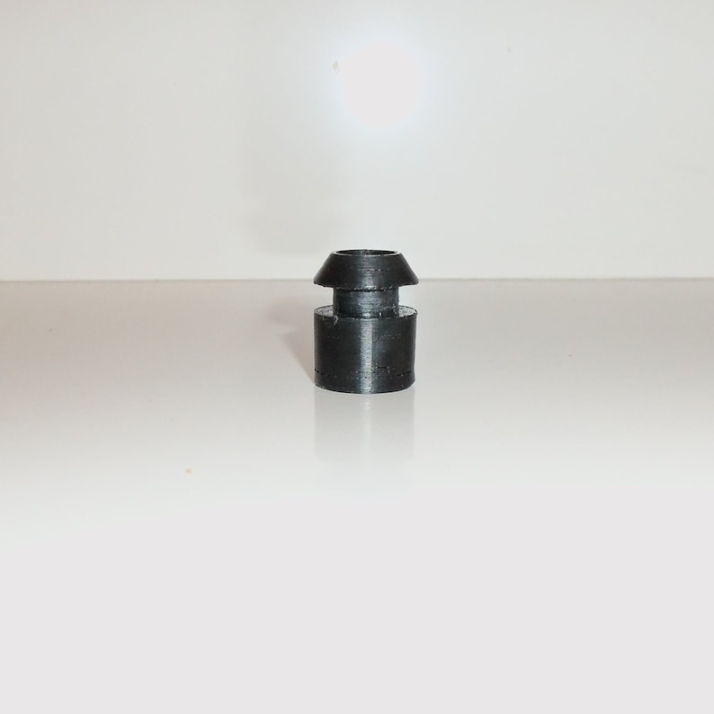 May include: A black rubber bottle stopper with a flared top.