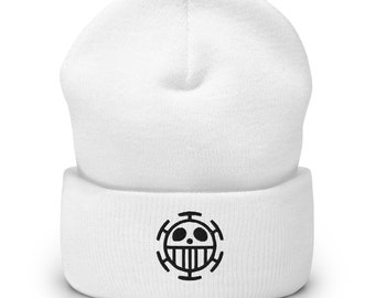 May include: White beanie with a black embroidered skull and crossbones logo. The logo is a circle with a skull in the center and four crossbones around the skull.