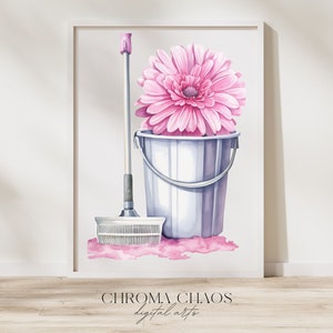 May include: A pink gerbera daisy sits in a white bucket with a pink mop and handle next to it. The background is a white wall.