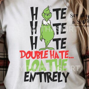 May include: White t-shirt featuring a Grinch graphic and the text "Hate, Double Hate, Loathe Entirely." The Grinch is green, and the text is in black, red, and green. Digital download.