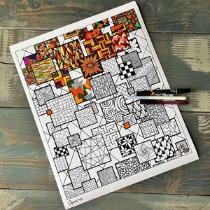 May include: A white sheet of paper featuring a hand-drawn grid of various squares filled with intricate black and white geometric patterns, with some squares partially colored in orange, yellow, and red. Three pens rest on the paper, which is labeled Squares.