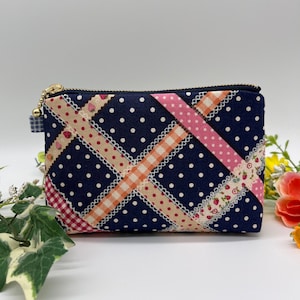 Zipper pouch with a cute strawberry ribbon and polka dot pattern. Made in Japan. Perfect for makeup and small items. Size A.