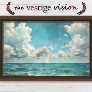 Puede incluir: Una impresión enmarcada de un paisaje marítimo con un cielo azul y nubes blancas. El océano es de color azul turquesa y las olas ruedan suavemente.