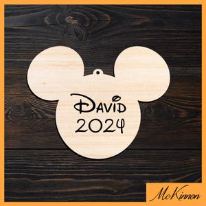 May include: Wooden ornament shaped like Mickey Mouse's head with the text "DAVID 2024" in black.