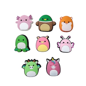 May include: Set of eight colorful cartoon animal charms, including a pink axolotl, a brown duck, an orange hamster, a green frog, a pink pig, a pink butterfly, a green dragon, and a pink unicorn.
