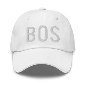 May include: White baseball cap with the word "BOS" embroidered in grey on the front.