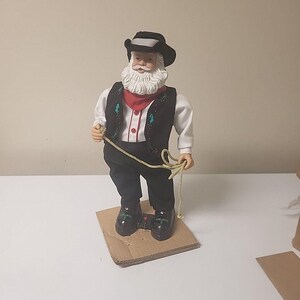 Vintage Holiday Time Dancing Animated Cowboy Santa önskar dig God Jul