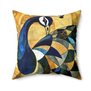 May include: A decorative throw pillow with a geometric design of a peacock in shades of blue, green, and gold.