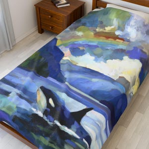 May include: Twin-size duvet cover featuring an orca breaching the water, with a rainbow and clouds in the background. The artwork is rendered in shades of blue, green, and yellow, creating a vibrant and artistic design. The bed cover is placed on a wooden bed frame.