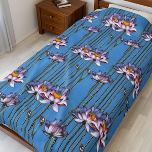 Blue Lotus Garden Velveteen Blanket – Vintage-style floral print with pink, purple, and golden blooms on vivid sky blue.