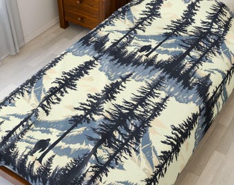 Bigfoot Amongst The Cascade Mountains Velveteen Blanket – Soft forest throw with Sasquatch design, perfect cozy cabin decor.