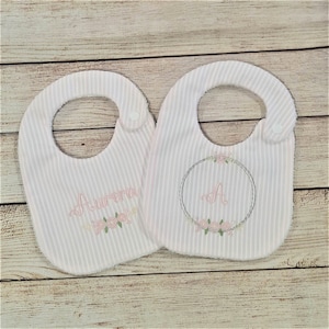 Personalized baby girl bibs, 2-piece set, with embroidered name and initial in delicate colors and floral border, birth or baptism gift
