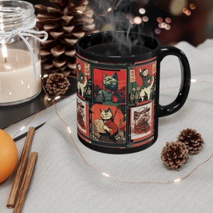 May include: Black coffee mug with a red and white design featuring cats in various poses. The design includes Chinese characters and the text "革命的猫" which translates to "Revolutionary Cats".