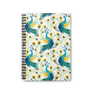 May include: A white spiral notebook with a colorful peacock pattern. The peacocks are blue, green, and yellow with white accents. The background is white with a subtle pattern of peacock feathers.