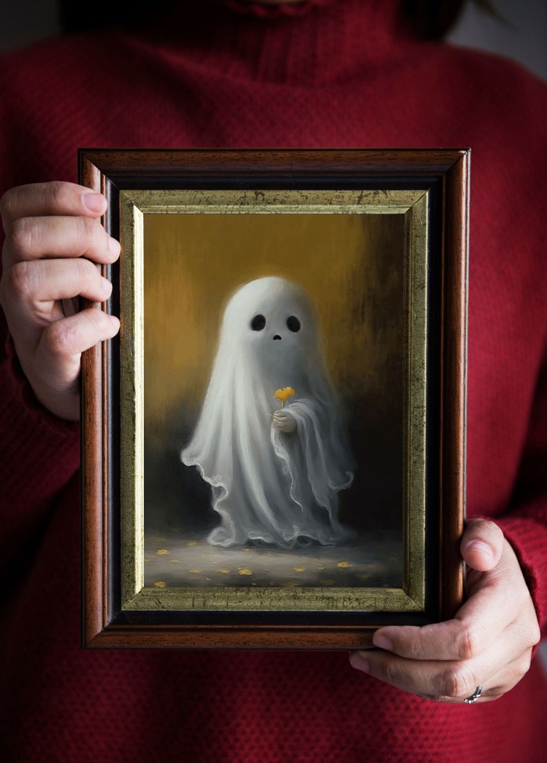 May include: A framed painting depicts a whimsical ghost holding a yellow flower. The ghost is draped in a white sheet, set against a golden background. The frame is dark brown with a gold inner border.