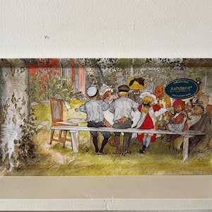 May include: A vintage-style metal tray featuring a colourful illustration of children gathered around a table outdoors. The tray has a green border with the text "Ashdene" in white lettering.