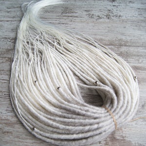 Gray to white synthetic dreadlock extensions. Twisted / smooth temporary dreads with loose ends. Single or Double ended locs with beads