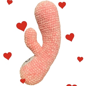May include: A pink plush toy shaped like a heart with a textured surface.