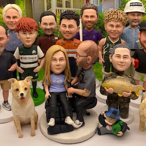 May include: A collection of 12 custom-made figurines, including people, animals, and a Monopoly man. The figurines are all different sizes and are made of a variety of materials, including ceramic, plastic, and fabric. The figurines are all standing on a white surface.