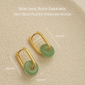 Elegant green jade hoop earrings with gold accents, 
 subtle yet sophisticated design.