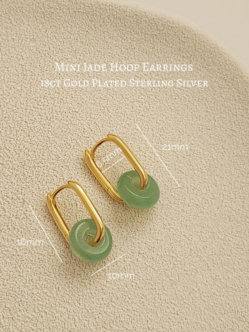 Elegant green jade hoop earrings with gold accents, 
 subtle yet sophisticated design.