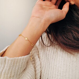 This Gold Clover Bracelet features a delicate four leaf clover charms, symbolizing good luck and prosperity. Crafted with 18k gold plated sterling silver, ideal for birthdays or anniversaries.