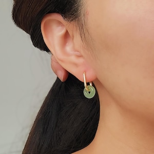 Model wearing green jade link hoop earrings with gold details, highlighting a chic and timeless accessory for any outfit.