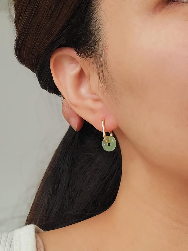 Model wearing green jade link hoop earrings with gold details, highlighting a chic and timeless accessory for any outfit.