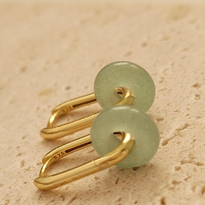 Close-up of a pair of green jade link hoop earrings, showcasing their elegant and minimalist design.