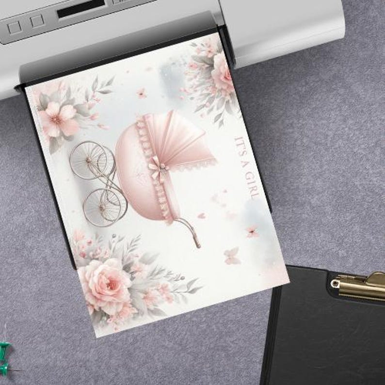 May include: A printed card featuring a pink baby carriage illustration with floral accents and the text "IT'S A GIRL." The design includes a vintage-style carriage, flowers, and butterflies, perfect for a baby shower or birth announcement.