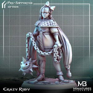 以下が含まれることがあります： 鎖とスパイクボールの武器を持った女性の3Dプリントミニチュア。白いチェック柄のドレスと髪にリボンをつけたキャラクター。ミニチュアは戦闘の準備が整ったダイナミックなポーズをとっている。ミニチュアには「Crazy Ruby」というラベルが貼られている。