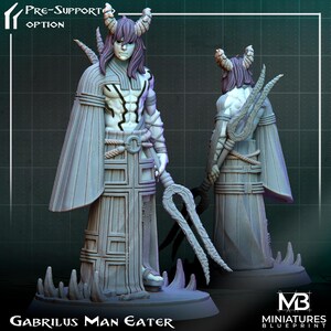 May include: A white painted miniature figurine of a demon with horns and a long, flowing robe. The demon holds a trident-like weapon in its right hand. The figurine is standing on a base with the text "Gabrilius Man Eater" printed on it.