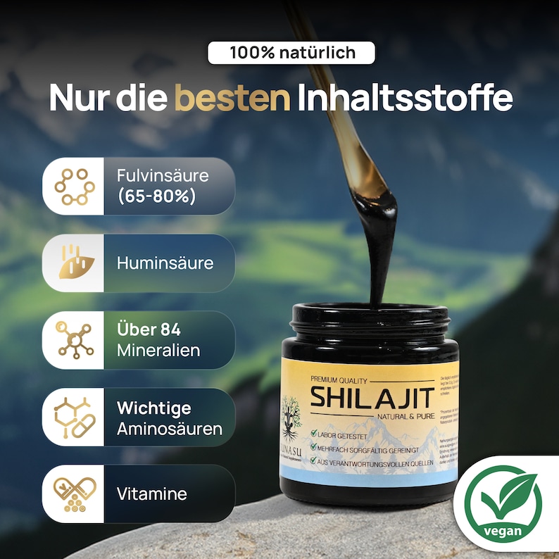 May include: A black jar with a gold label that reads "Premium Quality Shilajit Natural & Pure". The jar is filled with a thick, black substance. The label also includes the text "Labor Getestet", "Mehrfach Sorgfaltig Gereinigt", and "Aus Verantwortungsvollen Quellen". The jar is sitting on a brown surface with a green leaf icon that says "vegan".