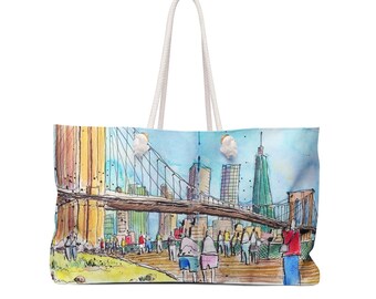 May include: Large tote bag featuring a watercolor illustration of a city bridge with people. The bag has a white rope handle and a rectangular shape. The artwork includes shades of blue, yellow, brown, and green.