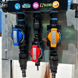 May include: Three black and blue water valves with red, blue, and yellow handles. The valves are labeled "Soft Wash Depot" and have a dial to adjust the flow. The valves are mounted on a metal panel with the text "EZ Blend" printed on it.