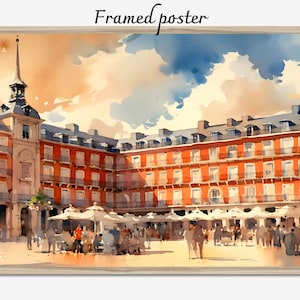 May include: Framed poster with a watercolour painting of a European square, showing red buildings, white parasols, and figures. The sky is a blend of blue, orange, and white. The text "Framed poster" is at the top.
