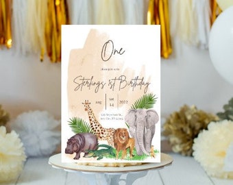 May include: A watercolor-style invitation for a first birthday party with a jungle theme. The invitation features a giraffe, elephant, lion, and hippopotamus. The text on the invitation reads "One Sterling's 1st Birthday Aug 14, 2022".