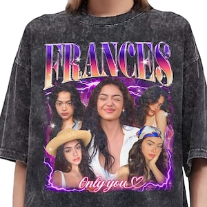 May include: Dark gray acid wash t-shirt featuring a graphic of a woman with the name "FRANCES" in a purple and orange gradient. The graphic includes multiple images of the woman and the text "Only you" with a heart symbol.