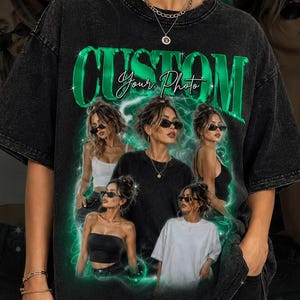 May include: Black t-shirt with a green "CUSTOM Your Photo" design. The shirt features a photo collage of a woman wearing sunglasses. The design is outlined with a green neon effect. The shirt is worn by a person.