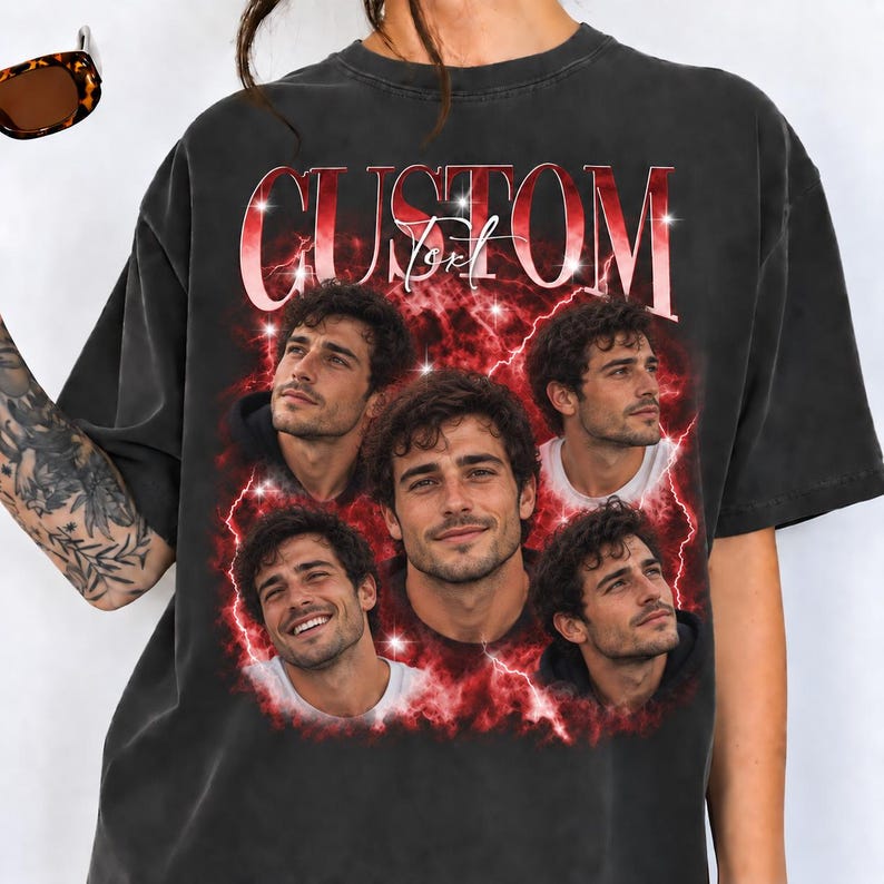May include: A charcoal gray short-sleeve t-shirt featuring the word CUSTOM in large red letters at the top. Below the text, five photographic portraits of the same man are arranged against a vibrant red lightning and cloud background.