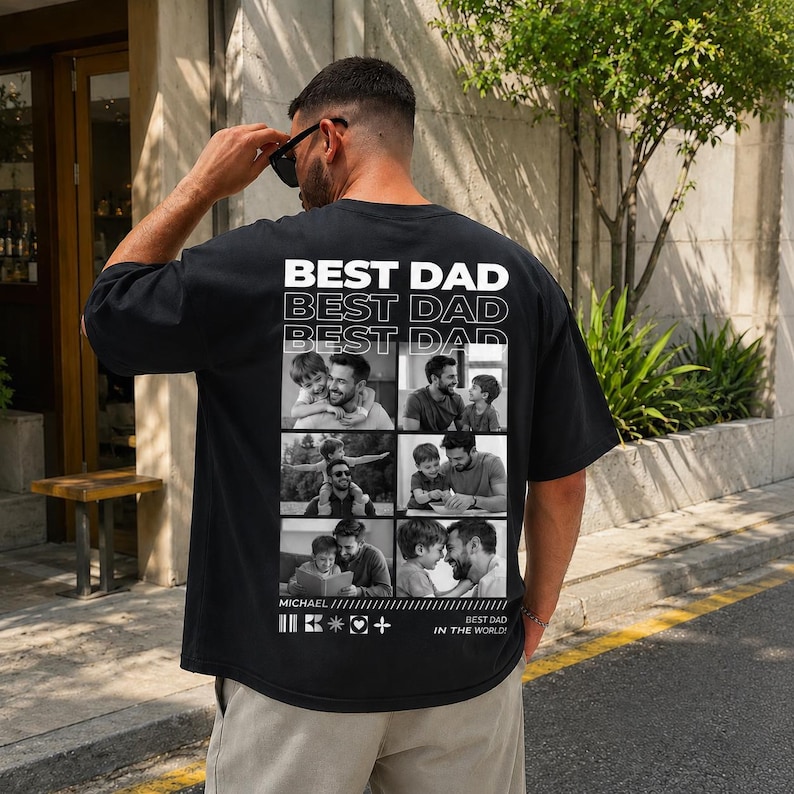 Puede incluir: Camiseta negra con el texto "BEST DAD" repetido tres veces en blanco. La camiseta presenta un collage de fotos en blanco y negro. El texto "MICHAEL" y "BEST DAD IN THE WORLD!" tambi&eacute;n est&aacute;n impresos en la camiseta.